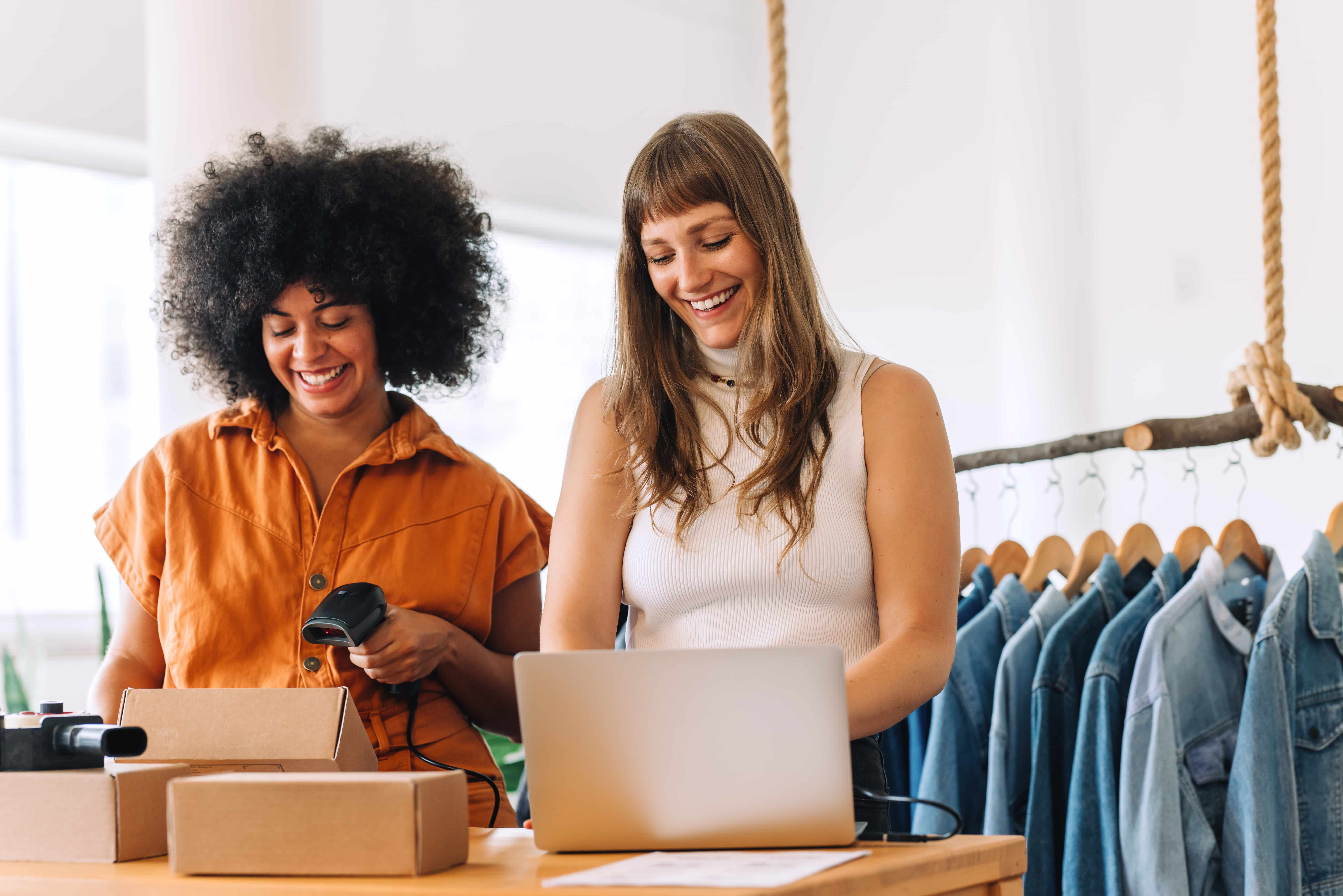 clothing store owners preparing parcels for shipping_538858070-min